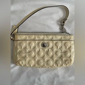 Coach cream colored wristlet